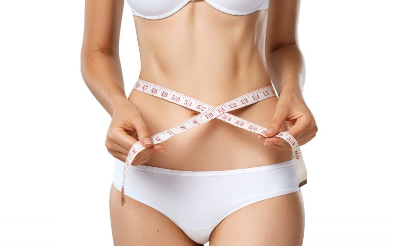 slim-tanned-woman-with-measure-tape-around-waist-CVRYLWT-min
